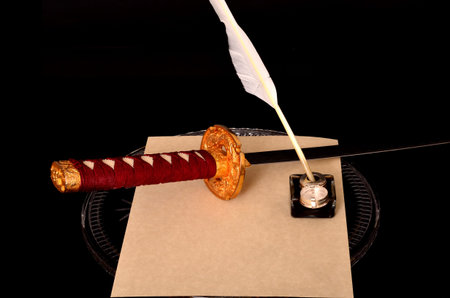 Quill parchment sword and ink well isolated over black