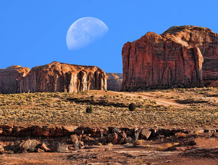 Large moon over Monument Valley Arizonaの写真素材