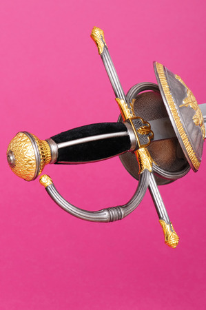 Rapier sword guard, and hilt isolated over pink