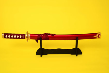 Samurai sword, Katana, Wakizashi and Tanto, isolated on yellow backgroundの写真素材