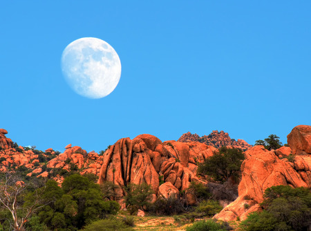 Desert moon over the southwestern USA desert and mountainsの写真素材