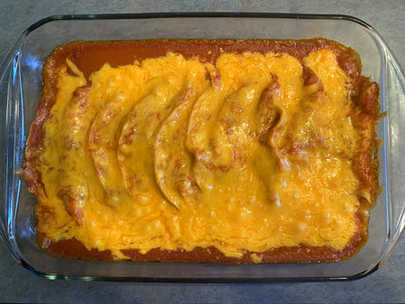 Chicken enchiladas in red chile sauce preparation