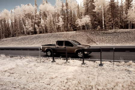 Pickup Truck in pine forest Northern Arizona by direction sign