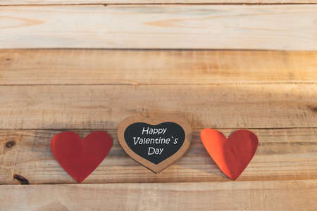 wooden blocks with red hearts and blackboard, Happy Valentines Day, on wooden backgroundの写真素材