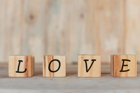 wooden blocks, horizontal with the word I love you, on a wooden backgroundの写真素材
