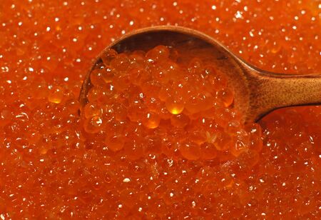 wooden brown spoon with red caviarの写真素材