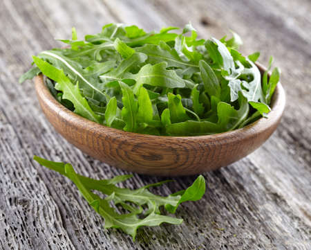 Arugula in a wooden backgroundの写真素材