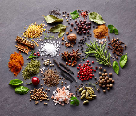 Herbs and spices on a black boardの写真素材