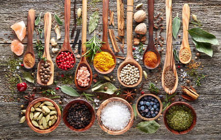 Herbs and spices  on a wooden boardの写真素材