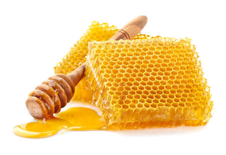Honeycombs with wooden spoon in closeupの写真素材