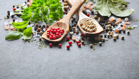 Spices and herbs on a graphite boardの写真素材
