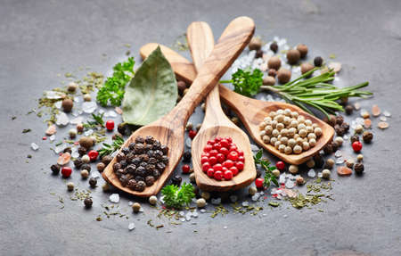 Spices and herbs on a black boardの写真素材