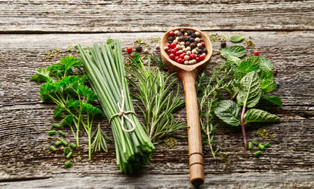 Fresh herbs and peppers spices on a wooden backgroundの写真素材