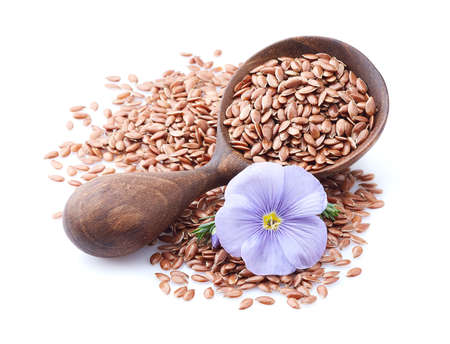 Flax seeds in wooden spoon on whiteの写真素材