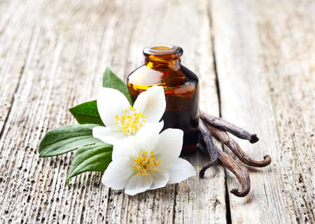 Jasmine and vanilla essential oil on wooden backgroundの写真素材