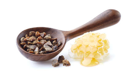 Propolis granule with honeycomb on white backgroundの写真素材