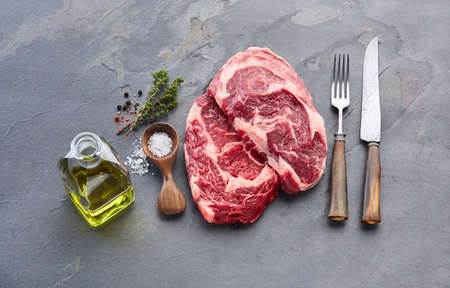 Ribeye beefsteak with spices on stone backgroundの写真素材