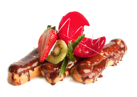 chocolate eclairs with strawberry, mint and rose