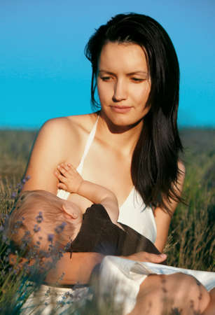 girl breastfeed baby on natureの写真素材