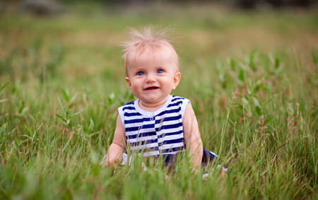 Cute little girl on the meadow in spring dayの写真素材
