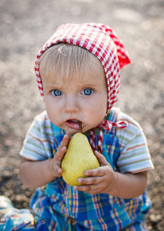 little funny girl eates a pearの写真素材