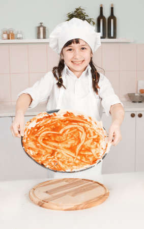 little girl chef preparing a pizzaの写真素材