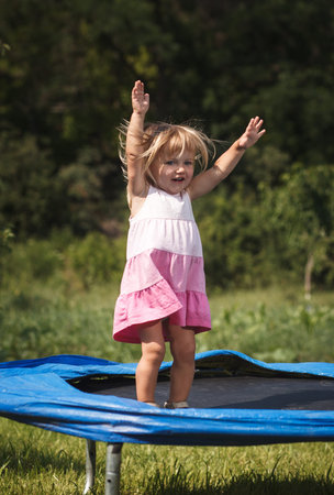 baby girl jumping on  trampolineの写真素材