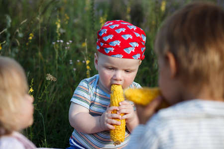 children with cornの写真素材