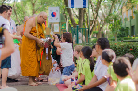 Giving alms to a Buddhist monkのeditorial素材