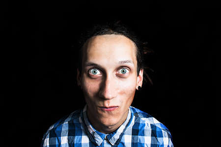 Portrait of a young cool man with dreadlocks on a black backgroundの写真素材