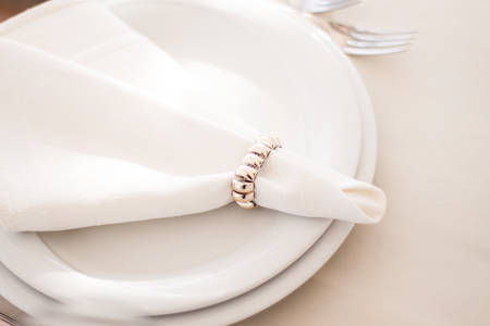 Place setting with plate knife and fork on tableの写真素材
