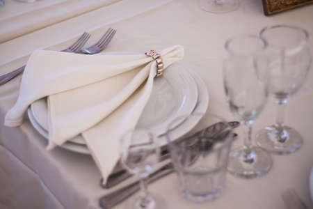 Place setting with plate knife and fork on tableの写真素材