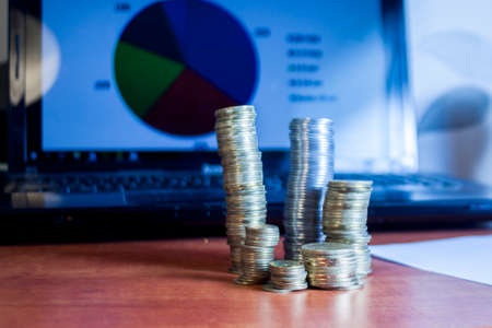 Business diagram on financial report with coinsの写真素材