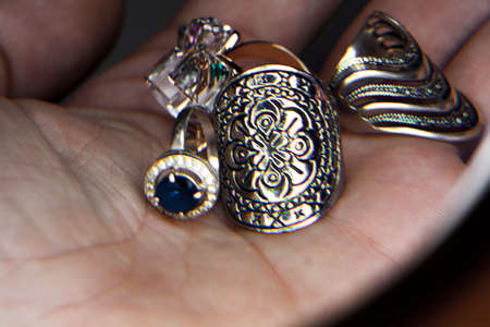 a lot of fashion rings in the handsの写真素材