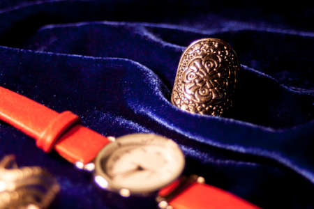 Closeup classic woman wristwatch with leather bracelet on a velvet blue backgroundの写真素材