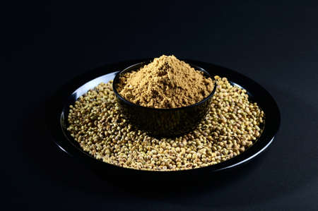 Coriander seeds and Powder on black backgroundの写真素材