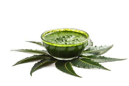 Medicinal Neem leaves with paste in bowl on white background.の写真素材