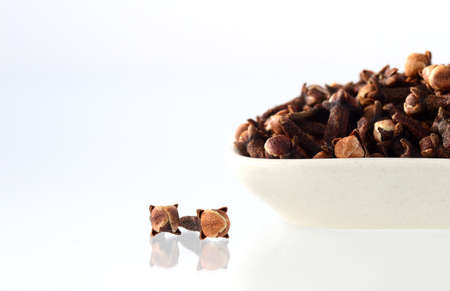 Cloves in plate isolated on white backgroundの写真素材