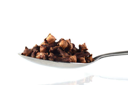 clove in spoon isolated on a white backgroundの写真素材