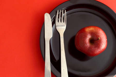 Ripe Red Apples on red backgroundの写真素材