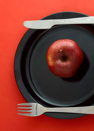 Ripe Red Apples on red backgroundの写真素材