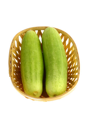 Fresh Cucumbers in basket isolated on white backgroundの写真素材