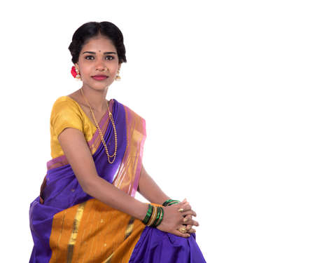 Beautiful Indian young girl posing in traditional Indian saree on white background.の写真素材