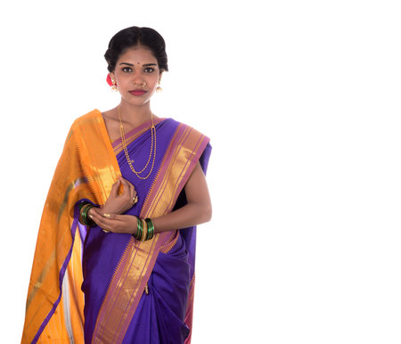 Beautiful Indian young girl posing in traditional Indian saree on white background.の写真素材