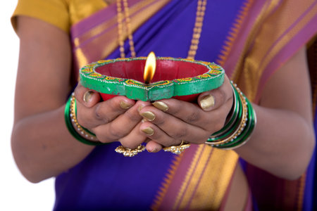 Portrait of a woman holding diya, Diwali or deepavali photo with female hands holding oil lamp...