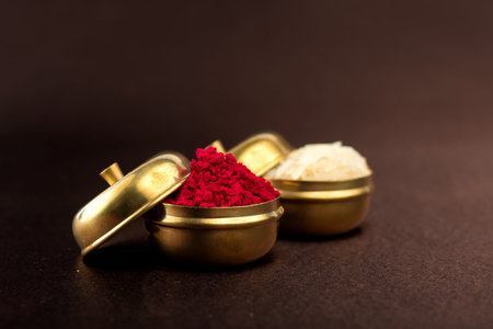Raksha Bandhan background with an elegant Rakhi, Rice Grains and Kumkum. A traditional Indian wrist band which is a symbol of love between Brothers and Sisters.の写真素材