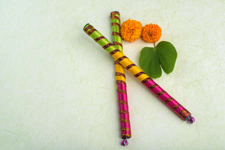 Indian Festival Dussehra, showing golden leaf (Bauhinia racemosa) and marigold flowers with Dandiya sticks.の写真素材