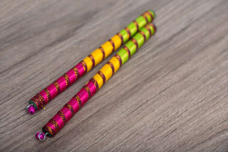 Dandiya sticks on a wooden background. Raas Garba or Dandiya Raas is the traditional folk dance form the state of Gujarat & Rajasthan in India.の写真素材