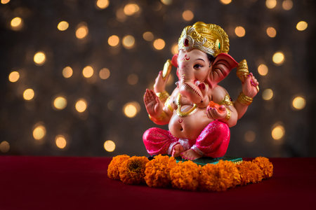 Hindu God Ganesha on Blured bokeh background, Ganesha Idol.