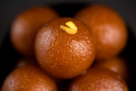 Gulab Jamun in bowl on black background. Indian Dessert or Sweet Dish.の写真素材